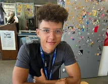 Graphic Design student Harvey at a desk